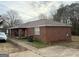 View of the brick exterior with a covered front porch area and parking at 241 E Ash St, Social Circle, GA 30025