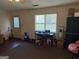 View of a living room featuring carpet and a view to the door and window at 241 E Ash St, Social Circle, GA 30025