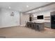 Basement bar with granite countertop, a TV, and a basketball hoop at 170 Newhaven Dr, Fayetteville, GA 30215