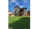 Expansive backyard featuring a wooden deck, lush lawn, and two-story home with neutral siding at 65 Waters Edge Ln, Covington, GA 30014
