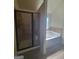 Modern bathroom with a glass-enclosed shower and a separate soaking tub at 65 Waters Edge Ln, Covington, GA 30014
