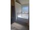 Soaking tub in well-lit bathroom with a tiled backsplash, window, and shower at 65 Waters Edge Ln, Covington, GA 30014