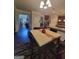 Dining area with hardwood floors, table set for four, and seamless access to the kitchen at 65 Waters Edge Ln, Covington, GA 30014