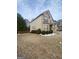 Well-maintained front yard featuring decorative landscaping and a lush lawn at 65 Waters Edge Ln, Covington, GA 30014