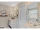 Double vanity bathroom with a large mirror and window at 13 Cheyenne Dr, Stockbridge, GA 30281