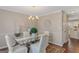 Formal dining room with glass table and chandelier at 13 Cheyenne Dr, Stockbridge, GA 30281