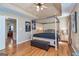 Main bedroom with four-poster bed, hardwood floors, and high ceilings at 252 Clifton Ln, Peachtree City, GA 30269