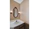 Powder room featuring a decorative mirror and wall sconces at 606 Ginger Cake Rd, Fayetteville, GA 30214