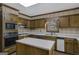 Kitchen with wood cabinets, appliances, and an island at 606 Ginger Cake Rd, Fayetteville, GA 30214