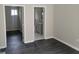 Cozy bedroom featuring dark floors and two doorways, one leading to a tiled bathroom at 304 Mercer Dr, Jonesboro, GA 30236