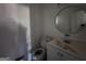 Bathroom with white vanity, toilet, and round mirror at 1879 Wrights Way, Jonesboro, GA 30236