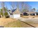 House exterior with stone and gray siding, solar panels and a garage at 3076 Carriage Trl, Jonesboro, GA 30236