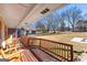 Relaxing front porch with wooden rocking chairs and backyard view at 3076 Carriage Trl, Jonesboro, GA 30236