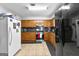 Galley kitchen with wood cabinets and stainless steel appliances at 3076 Carriage Trl, Jonesboro, GA 30236