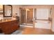 Bathroom featuring double sinks, granite countertops, soaking tub, and glass enclosed shower at 1320 Newbridge Cir, Buford, GA 30519