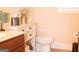 Toilet and vanity with an under-sink storage cabinet in this half bathroom with neutral colors at 1320 Newbridge Cir, Buford, GA 30519