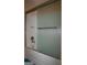 Bathroom showcasing a white bathtub with a textured glass sliding door and a brushed nickel towel bar at 1320 Newbridge Cir, Buford, GA 30519