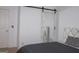 Bright bedroom features a mirrored sliding door and a comfortable bed with a gray comforter at 1320 Newbridge Cir, Buford, GA 30519