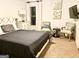 Bedroom featuring a bed with a gray comforter, neutral-toned walls, two chairs, and artwork hanging above the chairs at 1320 Newbridge Cir, Buford, GA 30519