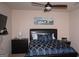 Cozy bedroom features a ceiling fan, a black leather headboard bed, and a calming blue color scheme at 1320 Newbridge Cir, Buford, GA 30519