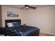 Serene bedroom boasts a ceiling fan, a black leather headboard bed, and a calming blue color scheme at 1320 Newbridge Cir, Buford, GA 30519