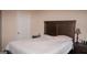 Neutral bedroom featuring a comfortable queen size bed with a wood headboard and side tables at 1320 Newbridge Cir, Buford, GA 30519