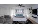 Relaxing bedroom with natural light, a ceiling fan, and comfortable seating area by the window at 1320 Newbridge Cir, Buford, GA 30519