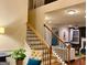 Bright foyer features a staircase and a view into the beautifully decorated living room at 1320 Newbridge Cir, Buford, GA 30519