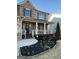 Charming home entrance with a cozy front porch and landscaped flower beds at 1320 Newbridge Cir, Buford, GA 30519