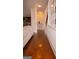 Hallway showcasing hardwood floors leading to the kitchen and staircase at 1320 Newbridge Cir, Buford, GA 30519