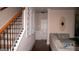Hallway with hardwood floors, staircase, and a comfortable living area at 1320 Newbridge Cir, Buford, GA 30519