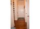 Hallway with hardwood flooring and white walls adorned with Gathering portraits at 1320 Newbridge Cir, Buford, GA 30519