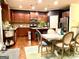 Eat-in kitchen with stainless appliances, granite countertops, island seating, and a distressed wooden table at 1320 Newbridge Cir, Buford, GA 30519
