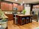 Open kitchen with stainless steel appliances, granite countertops, island seating, and updated fixtures and finishes at 1320 Newbridge Cir, Buford, GA 30519