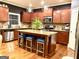 Open kitchen with granite countertops, stainless steel appliances, a center island with seating, and pendant lighting at 1320 Newbridge Cir, Buford, GA 30519