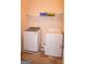 Bright laundry room with modern appliances and storage shelves for household items at 1320 Newbridge Cir, Buford, GA 30519