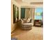 Cozy seating area with stylish chair and artwork in the spacious main bedroom at 1320 Newbridge Cir, Buford, GA 30519