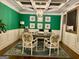 Home office with green walls, coffered ceiling, and patterned rug at 1320 Newbridge Cir, Buford, GA 30519