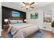 Bright bedroom with a dark accent wall and ceiling fan at 130 Belmont Farms Dr, Ellenwood, GA 30294