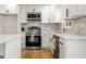 Renovated kitchen, featuring stainless steel appliances and white cabinets at 130 Belmont Farms Dr, Ellenwood, GA 30294