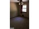 Empty carpeted bedroom featuring a window with blinds allowing natural light to flow in at 1760 Upland Ridge Nw Dr, Conyers, GA 30012