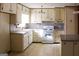 View of kitchen with white cabinets and a breakfast bar at 1760 Upland Ridge Nw Dr, Conyers, GA 30012