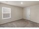 Cozy bedroom featuring carpet, a window with venetian blinds, and a white door at 144 Oliver Dr, Locust Grove, GA 30248