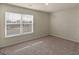 Cozy bedroom featuring carpet and a window with venetian blinds at 144 Oliver Dr, Locust Grove, GA 30248