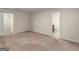 Neutral bedroom with carpet flooring and a door to an ensuite bathroom at 144 Oliver Dr, Locust Grove, GA 30248