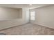 Cozy bedroom featuring neutral carpet, natural light, and a private closet at 144 Oliver Dr, Locust Grove, GA 30248