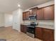 Kitchen featuring stainless steel appliances, dark wood cabinets, and wood-look floors at 144 Oliver Dr, Locust Grove, GA 30248