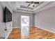 Main bedroom with hardwood floors, tray ceilings, and doors leading to the sunroom at 2175 Ashton Dr, Villa Rica, GA 30180