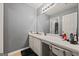 Bathroom features a vanity, sink, large mirror and overhead lighting at 8264 Milam Loop, Fairburn, GA 30213