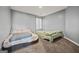 Bedroom with two beds, neutral grey walls, carpeted floor, and a window providing natural light at 8264 Milam Loop, Fairburn, GA 30213